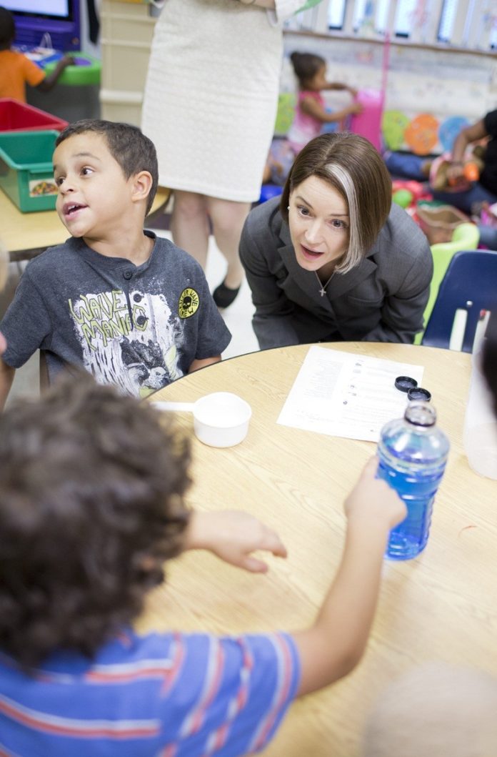 DEBORAH A. GIST, Rhode Island's commissioner of elementary and secondary education, talks with children last year at the Smith Hill Early Childhood Learning Center in Providence following a news conference announcing grant awards. This week, the state department received a federal $2.3 million grant to expand prekindergarten programs in seven communities.  / COURTESY R.I. DEPARTMENT OF EDUCATION