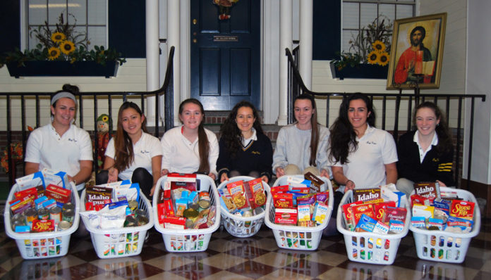 FROM LEFT: Bay View Academy students Dakota Grenier, Yaewon (Brittany) Ha, Madeline Chrupcala, Samantha Crausman, Juliana Kohler, Delia Sosa and Christina DesVergnes pose with their donations of Thanksgiving staples to benefit families in need.