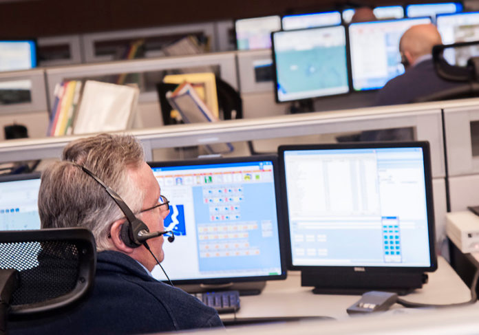 GETTING THE CALL: A report from Brown University’s Taubman Center recommends consolidating municipal 911 services across Rhode Island. Above, a 911 dispatcher works at the Scituate call center. / PBN PHOTO/MICHAEL SALERNO