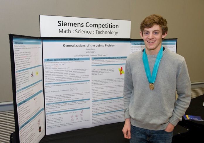 JOSEPH ZURIER, a Classical High School senior, placed second this month in the 2014 Siemens Competition in Math, Science & Technology, a national research competition for high school students. He is shown with his project, 