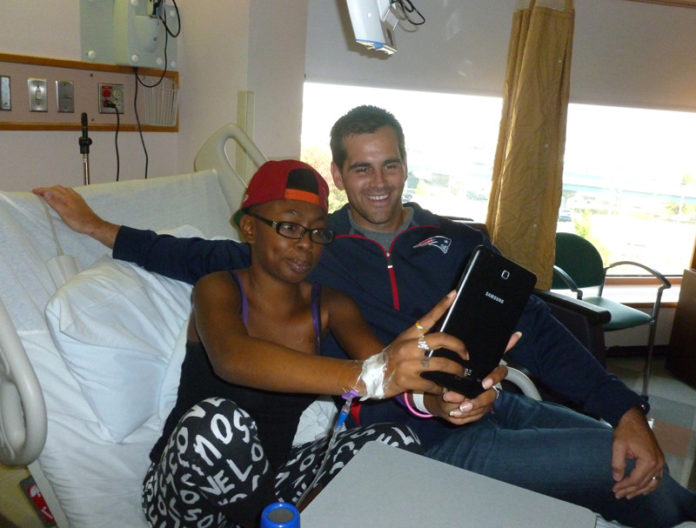 RAJEEYAN MOODY, left, poses with New England Patriots player Stephen Gostkowski during a visit to Hasbro Children’s Hospital. The visit commenced the first day of the player’s Kick 4 Kids fundraising campaign, which will see him match up to $10,000 in donations.