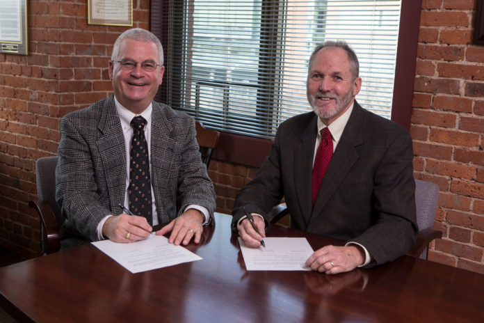 CARE NEW ENGLAND President and CEO Dennis D. Keefe, left, and The Providence Center's President and CEO Dale Klatzker, right, are shown signing the formal agreement which affiliates the two organizations. / COURTESY JOE GIBLIN