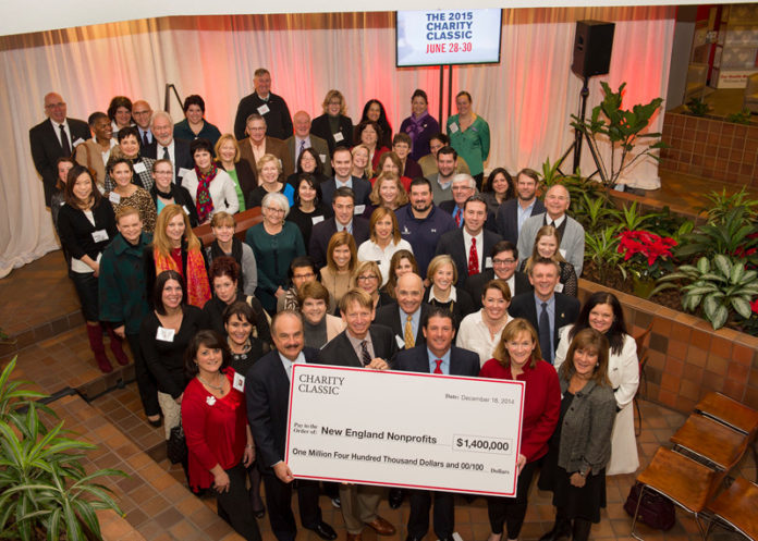 Nearly 80 nonprofit organizations gather on Dec. 18 at CVS Health’s Woonsocket headquarters to share in $1.4 million donated from the 2014 Charity Classic. The tournament, which attracts some of the world’s top professional golfers, has raised more than $18 million since its inception for charitable organizations throughout the region. Front row, from left: CVS Health President and CEO Larry Merlo; tournament co-host and golf professional Brad Faxon; co-host and golf professional Billy Andrade; tournament Chairwoman Eileen Howard Boone and CVS Health Senior Director of Community Relations Faith Weiner. / COURTESY CONSTANCE BROWN PHOTOGRAPHY