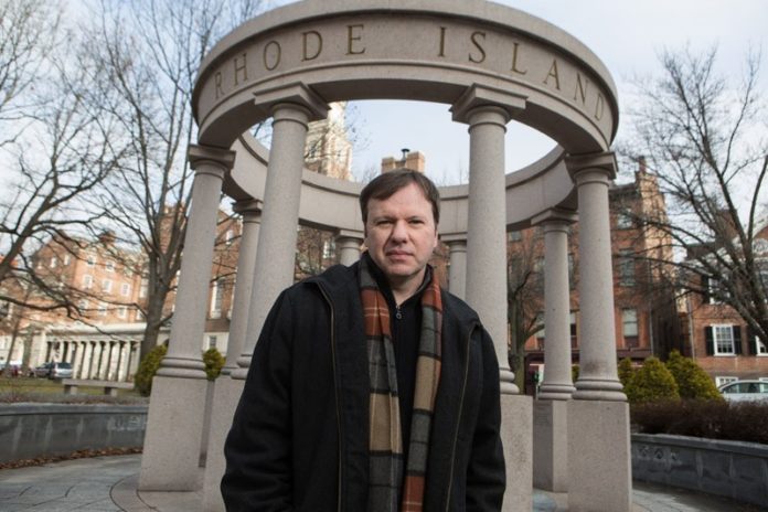 OF VILLIANS AND HEROES: Tim Gray, seen here at the Providence World War II memorial, has made a dozen films about the participants of World War II. / PBN PHOTO/RUPERT WHITELEY