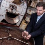 FRESH BREW: Michael Kapos, vice president of sales and marketing at Excellent Coffee, a family-owned business in Pawtucket. Two of Excellent Coffee’s staple brands are Ocean Coffee Roasters, an “ultra-premium, micro-roasted” coffee, and Downeast Coffee, which has been produced for nearly 60 years. / PBN PHOTO/MICHAEL SALERNO