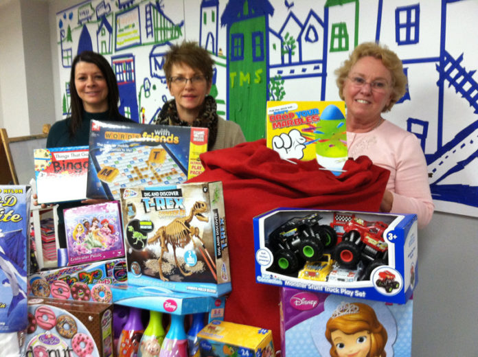 BANKNEWPORT VICE PRESIDENT and Middletown Branch Manager Linda Buchanan, left, presents toys to the Dr. Martin Luther King Jr. Community Center after toys were collected during the Bank’s Stuff the Truck event. Marilyn Warren, executive education director, center, and Sally Swistak, education director, right, were present to accept the donations.