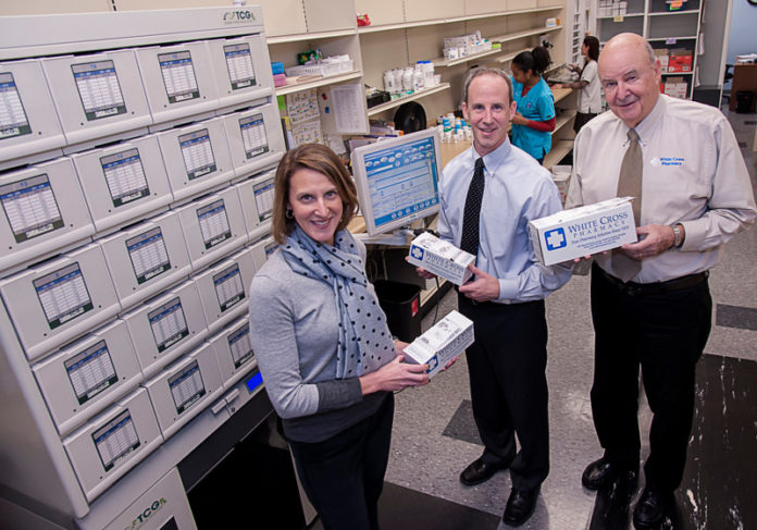 CROSS ROAD: White Cross Pharmacy has grown into a third-generation, family-owned business serving clients in three states by constantly working to meet the changing needs of customers. Pictured above, from left, are: Beth Brown, business director; Robert J. Iacobucci, pharmacy director; and Robert L. Iacobucci, company president and CEO. / PBN FILE PHOTO/MICHAEL SALERNO
