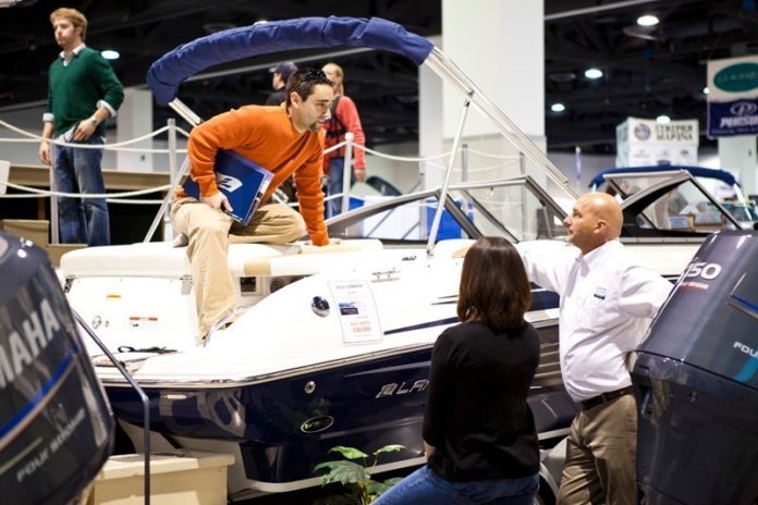 BEST IN SHOW: At a recent Providence Boat Show, an attendee, left, speaks to a company representative about a motorboat, the 2012 Larson LX2150. / COURTESY ERIN MCGINN