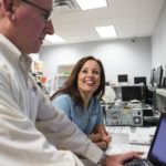 SKILLED LABOR: Lisa Shorr, co-owner of Secure Future Tech Solutions, works with remote support engineer Ben Lyopns. Her husband and company co-owner, Eric Shorr, says finding qualified employees is the firm&rsquo;s No. 1 hurdle. / PBN PHOTO/RUPERT WHITELEY