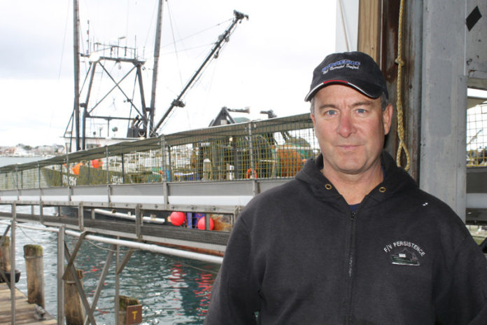 For nearly two decades the once-booming East Coast butterfish market has been dormant. But that could change. In the past two years NOAA Fisheries has begun raising the butterfish quota. Rhode Island fishermen and fish  sellers, including Glenn Goodwin, co-owner of SeaFreeze Ltd., are now looking for ways to reclaim a lost market. Above, Goodwin stands alongside the take-out chute at SeaFreeze Shoreside in Narragansett. / PBN PHOTO/JOHN LEE