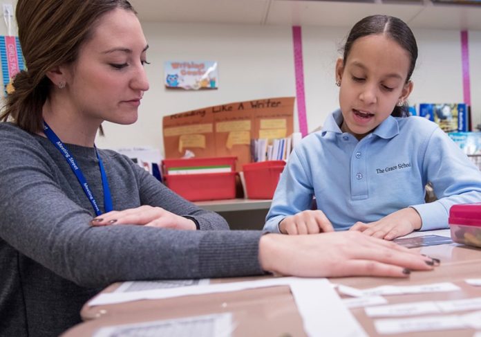 INCLUDING STUDENTS: Kim Scuito, a fourth-grade teacher at the Grace School, works with student Yolanny Estevez. The division of Meeting Street works toward an inclusive approach for students with disabilities. / PBN PHOTO/MICHAEL SALERNO INCLUDING STUDENTS: Kim Scuito, a fourth-grade teacher at the Grace School, works with student Yolanny Estevez. The division of Meeting Street works toward an inclusive approach for students with disabilities. / PBN PHOTO/MICHAEL SALERNO