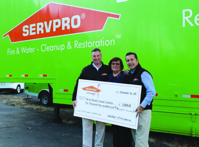 CHRIS GAGNON, general manager of Servpro of Providence, left, and Frank Mattos, president and owner of Servpro of Providence, right, present $2,500 to Marlene McCarthy, co-founder of the Rhode Island Breast Cancer Coalition, center, after Servpro held a successful social media campaign.