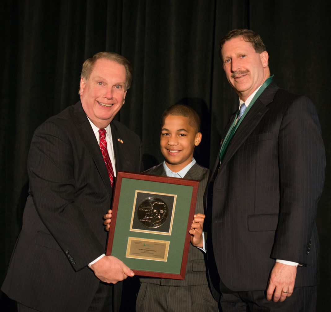 JA’s Education Committee Chairman, Steve Kitchin of New England Tech, presents President/CEO Neil Steinberg with The Rhode Island Foundation’s 2014 award. With Neil is Hamlet Suazo, a student from his JA class at Carl Lauro Elementary School.