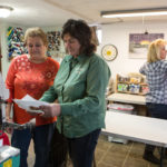 STITCHED TOGETHER: Ocean State Embroidery Inc. co-owner Robin Moorehead, third from left, was able to purchase new equipment for her business with the help of a Navigant Credit Union loan. She's pictured above, from left, with Joseph Morel, Debbie Lowell and Mary Ellen. / PBN PHOTO/?RUPERT ?WHITELEY