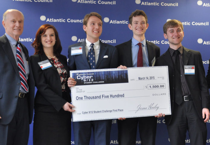 A BROWN UNIVERSITY UNDERGRADUATE cybersecurity team - Celina Stewart, second from left, Luke Camery, Sam Brebner, and Jared Schober, standing with coach John Savage - had the best plan and made the best urgent decisions to deal with a fictitious cyber attack scenario in the Philippines, winning a Cyber 9/12 Student Challenge last weekend in Washington, D.C. / COURTESY THE ATLANTIC COUNCIL