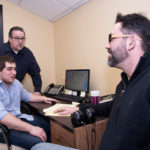 Lighting way in transport GETTING THERE: Beacon Shipping Logistics co-owners Fred Deschamps, left, and Eric Broomfield, right, along with Executive Partner Ryan Denault, seated, review upcoming deliveries on Google Maps. Roughly 35 percent of the firm's business is delivering automobiles on order for consumers. / PBN PHOTO/MICHAEL SALERNO