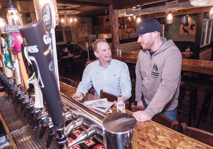 READY TO EAT: David Rosenberg, left, owner of Newport County Dinner Club, meets with the owner of The Wharf Pub, Scott Kirmil. Rosenberg continues to sign up renewals and add new members to the club. / PBN PHOTO/MICHAEL SALERNO READY TO EAT: David Rosenberg, left, owner of Newport County Dinner Club, meets with the owner of The Wharf Pub, Scott Kirmil. Rosenberg continues to sign up renewals and add new members to the club. / PBN PHOTO/MICHAEL SALERNO