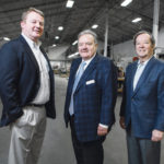SMART INVESTMENT: Since President and CEO Thomas Melucci, center, and Richard Bready, right, bought Hope Valley Industries out of bankruptcy in 2002, the company has made a mark on the global automobile market, becoming recognized by both Ford and GM for the quality of its floor mats, produced under the guidance of Executive Vice President Craig Melucci. / PBN PHOTO/RUPERT WHITELEY