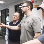 SEEING OPPORTUNITY IN TEAMWORK: Fred Santaniello, left, director, workforce training grants and programs, and coordinator of the SAMI program, works with students Rob Santos, center, and Teddy Small, in one of New England Tech's labs. / PBN PHOTO/RUPERT WHITELEY