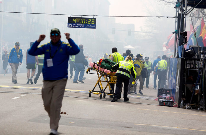 FIRST RESPONDERS rush to where two explosions occurred along the final stretch of the Boston Marathon on Boylston Street in Boston on April 15, 2013. A jury in Boston federal court convicted Dzhokhar Tsarnaev on Wednesday of carrying out the biggest terror attack on U.S. soil since 2001; now jurors in the Boston Marathon bombing case will decide if he should die or spend life in prison. / BLOOMBERG/KELVIN MA