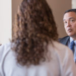 HEALTH MATTERS: Dr. Al Kurose, CEO of Coastal Medical in Providence, on right, talks recently with the new wellness clinical team about the value of their Medicare Annual Wellness Visit center, which opened in March. The team includes, from left, nurse practitioner Christina Botelho and pharmacist Elyse Leandro. / COURTESY BILL GALLERY