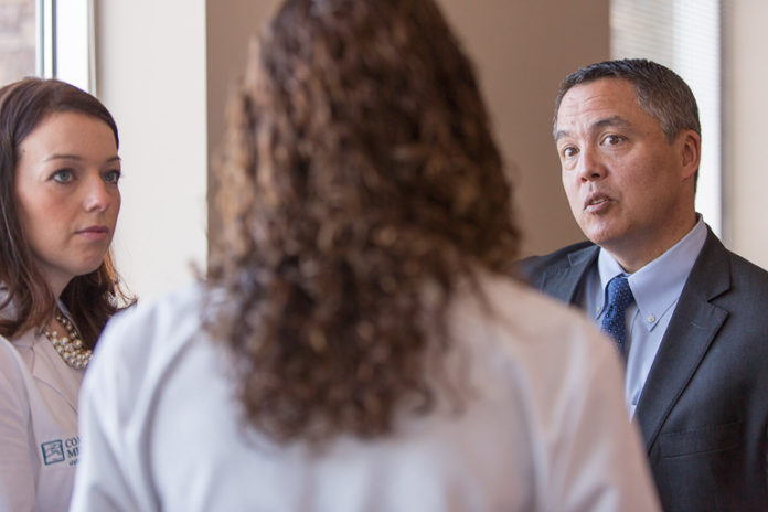 HEALTH MATTERS: Dr. Al Kurose, CEO of Coastal Medical in Providence, on right, talks recently with the new wellness clinical team about the value of their Medicare Annual Wellness Visit center, which opened in March. The team includes, from left, nurse practitioner Christina Botelho and pharmacist Elyse Leandro. / COURTESY BILL GALLERY