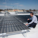 BRIGHT IDEA: Christopher Morra Sr., president and CEO of National Security, shows off a solar panel system that he said in 2014 had saved the company $8,631 in 13 months. / PBN FILE PHOTO/MICHAEL SALERNO