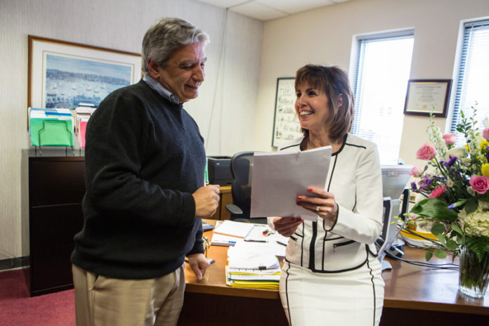 COMING TOGETHER: Beta Group Senior Vice President Donna Lantagne has been able to climb the ladder at the company due to her hard work and abilities. At left, Lantagne reviews documents with Beta Group President and CEO Frank J. Romeo. / PBN PHOTO/RUPERT WHITELEY