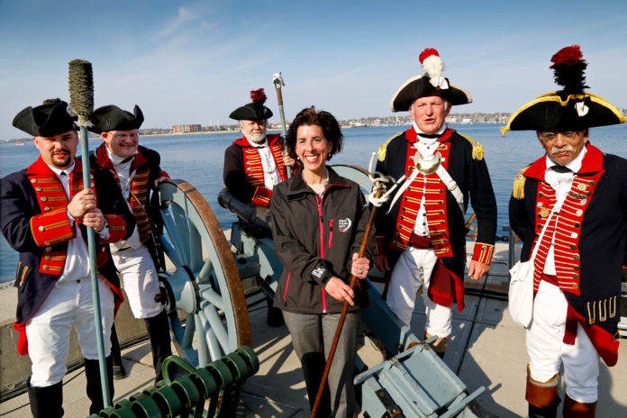 GOV. GINA M. Raimondo poses with the Artillery Company of Newport during the opening ceremony for the Volvo Ocean Race Newport Race Village. / COURTESY DAN NERNEY/SAIL NEWPORT/VOLVO OCEAN RACE NEWPORT