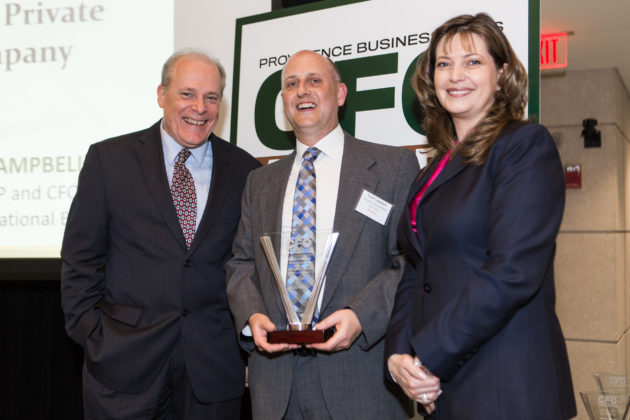 Trad Campbell, Freedom National Bank, accepts his award from Mark Murphy, PBN and Kristin Fraser, KPMG / Rupert Whiteley