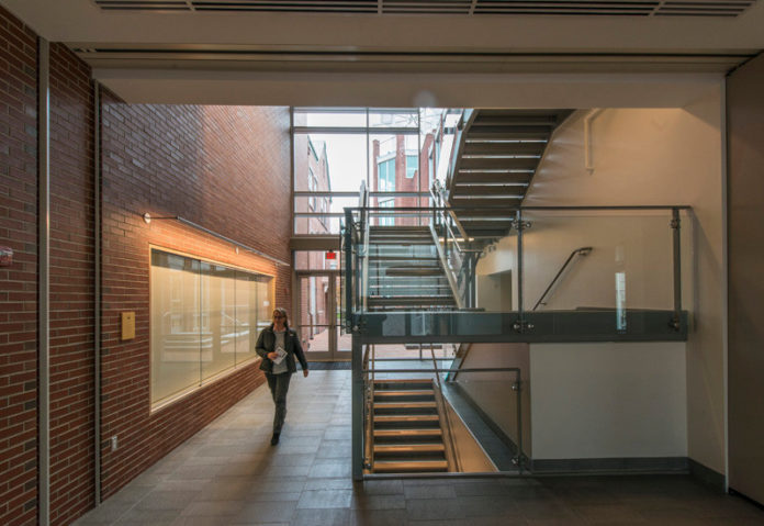 A HALLMARK: The staircase and lobby that connect Wheeler Hall to the new addition used glass and steel elements to increase light in the space.
