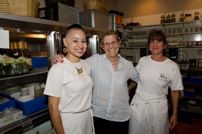 TIPPING POINT: Deb Norman, center, owner of Rue De L'Espoir, with employees Casandra Robinson, left, and Alycyn Bouckaert. Norman thinks the the tipped minimum wage should be raised by a dollar a year for at least three years. / PBN PHOTO/ JAIME LOWE