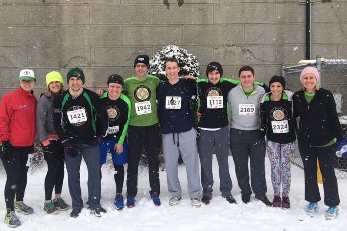 DEDICATED TO THE CAUSE: In this case, CBIZ Tofias employees took part in the 2015 St. Patrick's Day 5K, despite the less-than-ideal conditions for running. / COURTESY CBIZ Tofias