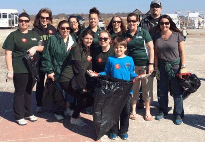CONNECTING WITH COMMUNITY: People's Credit Union sponsors a number of events for employees, including community cleanups. / COURTESY PEOPLE'S CREDIT UNION