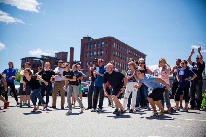 SHAPING UP: Contestants take part in the annual Run Rib Chug relay race, in which teams must run around their office building, eat a rib and chug a beverage. / COURTESY SHAPEUP