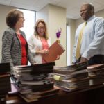 Balance improves work, life POSITIVE THINKING: Operating in Providence for six years, Hartford, Conn.-based Robinson & Cole works to foster a positive atmosphere in the office. Pictured above, from left, are partner Patricia Igoe, legal administrative assistant Heidi Seddon and George Watson. / PBN PHOTO/RUPERT WHITELEY