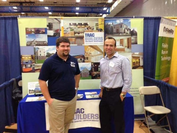 IN SEARCH OF THE NEXT GENERATION: TRAC Builders Project Engineer Alex Bradley, left, and Vice President Nelson Ferreira at a STEM job fair. / COURTESY TRAC BUILDERS