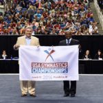 FROM LEFT to right, John Gibbons, executive director of the R.I. Sports Commission receives the ceremonial flag from USA Gymnastics Chief Operating Officer Ron Galimore at the recent 2015 Championships held in Greensboro, N.C. Providence has been chosen to host the 2016 USA Gymnastics Championships.

 / COURTESY PROVIDENCE WARWICK CONVENTION & VISITORS BUREAU