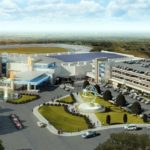 PLAINRIDGE PARK CASINO, seen here in an aerial rendering, opened for business June 24, and according to at least one observer, former University of Massachusetts professor Clyde W. Barrow, it had an "absolutely astronomical" first week of revenue generation.  / COURTESY PLAINRIDGE PARK CASINO