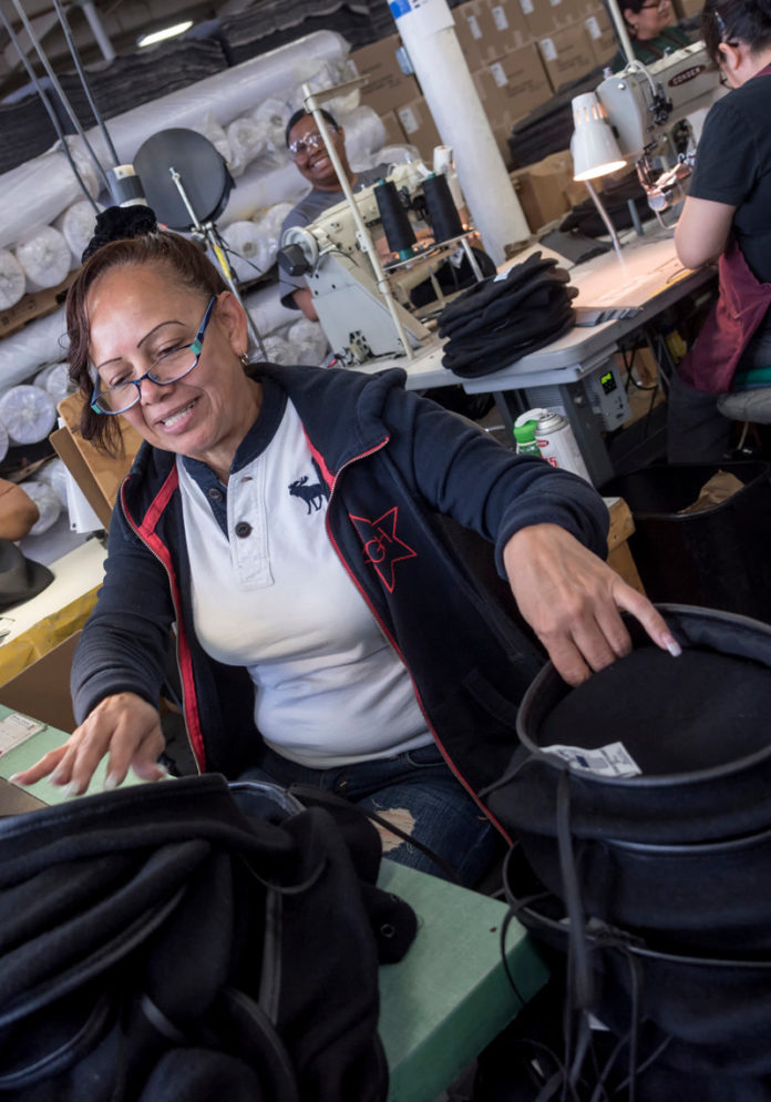 HEAD START: Maria Garcia on the production line at The Brickle Group in Woonsocket. / PBN PHOTO/MICHAEL SALERNO