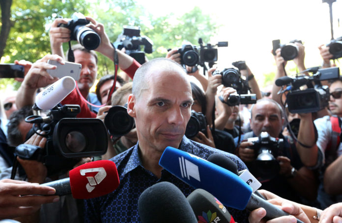 YANIS VAROUFAKIS, Greece's outgoing finance minister, speaks to the media as he exits the finance ministry following his resignation in Athens on Monday. European stocks dropped, and the euro weakened as Greek voters' rejection of austerity sent investors to the relative safety of Treasuries, German bunds and the yen. / BLOOMBERG NEWS PHOTO/CHRIS RATCLIFFE