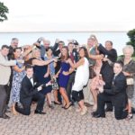 2015 40 Under Forty Photos Honoree Taryn Groves Moran, Gordon Research Networks, surrounded by friend and family / Skorski Photography