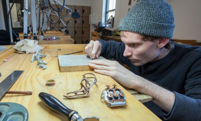 CROWN JEWEL: Rhode Island College student John Deignan works on jewelry design. The school's jewelry-design program is one of two offered in the state. / COURTESY RIC