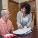 Firm stays connected MISSING LINK: Transportation brokerage firm Trans-Link LLC on clear communication with the shipper, shipment receivers and drivers do ensure timely delivery. Above, Carla Manni, president of Trans-Link LLC, meets with staff logistics specialist Kyle Badolato. / PBN PHOTO/MICHAEL SALERNO