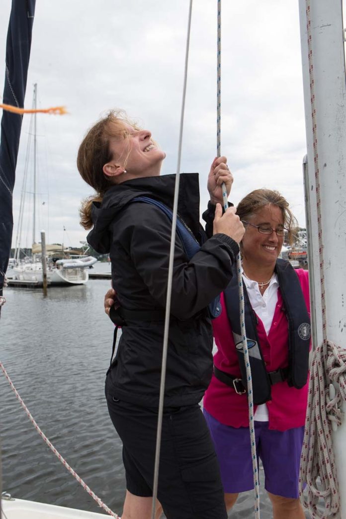 LEARNING THE CRAFT: Narragansett Sailing LLC instructor Jan Moiz, right, works with student Marjoliane Marcotte, a student from Canada, in July. / PBN PHOTO/RUPERT WHITELEY