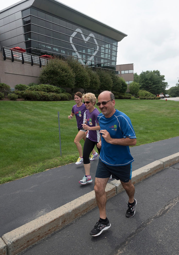 UP TO SPEED: Through a series of wellness, nutritional and fitness initiatives, CVS Health has a healthier workforce, and a better handle on health care costs. Employees training for the CVS Downtown 5K at company headquarters in Woonsocket are, from left, Sheila Bowe, and Carmen and Les Steinbrecher / PBN PHOTO/MICHAEL SALERNO