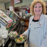 MAKING HEALTH A PRIORITY: South County Health looks to improve the health and wellbeing of employees as well as patients, offering, among other things, healthy food choices at the on-site dining room, including pharmacist Deborah Cote's choice, a 310-calorie Southwestern grilled chicken salad. / PBN PHOTO/MICHAEL SALERNO