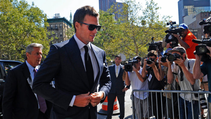 TOM BRADY, quarterback for the New England Patriots, center, arrives at federal court in New York on Aug. 12. A U.S. District Court judge on Thursday overturned Brady's four-game suspension for using underinflated footballs in a January playoff game.
 / BLOOMBERG NEWS FILE/ LOUIS LANZANO