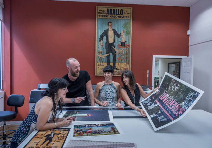 INSIDE JOB: Archives and Ephemera Design specializes in work that combines photos, prints, paintings and vintage advertising that can add up to 250-350 pieces. Pictured above, from left, are: employees Cindy Bean, Andy Morris, Karen Cafaro and owner Rena Nathanson. / PBN PHOTO/MICHAEL SALERNO
