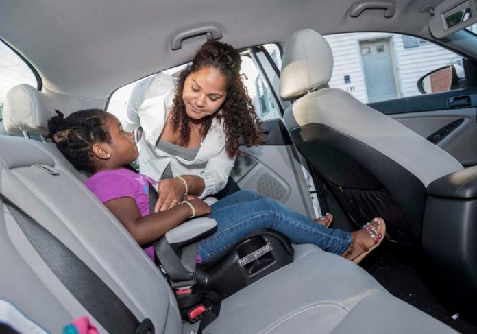 NEW RIDE: Sherlie Martinez and her daughter, Akemi, 5, of Cranston, with the 2013 Kia Optima that Martinez purchased with one of the first loans provided a new car loan service from the Capital Good Fund. / PBN PHOTO/ MICHAEL SALERNO